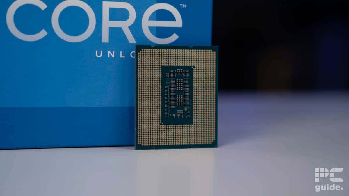 Intel Core i5-12600K processor in front of its packaging box with "core" and "unlocked" visible on a blurred blue background.