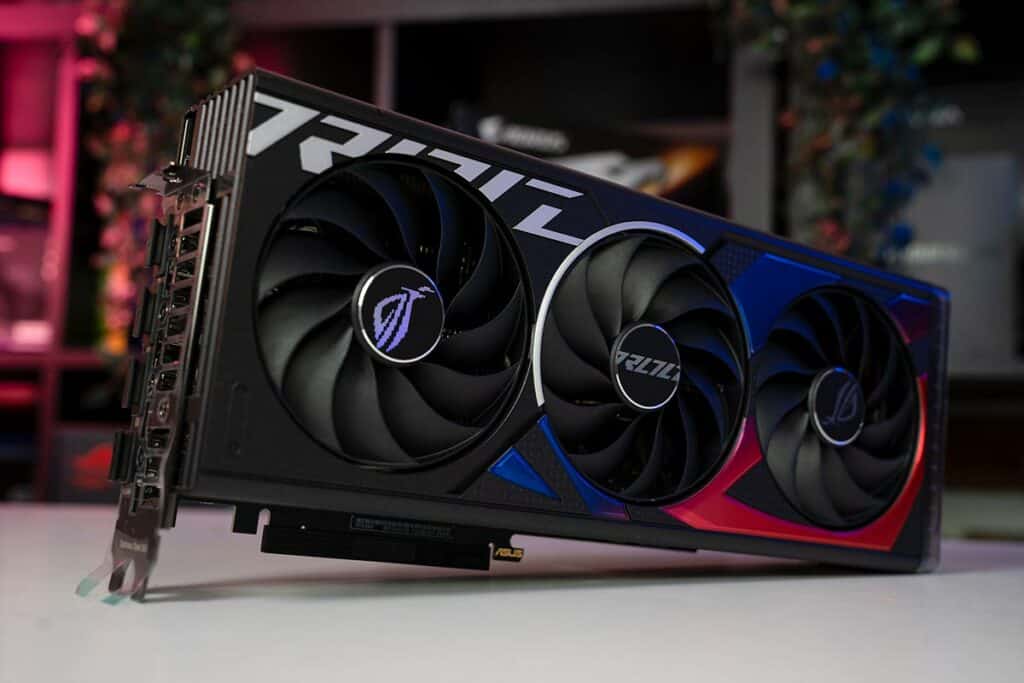 A high-performance RTX 4060 graphics card with triple-fan cooler design on a desk with colorful background lighting.