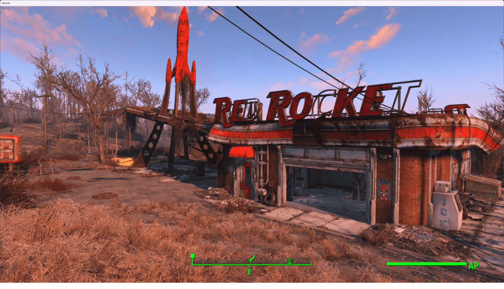 A dilapidated red rocket gas station featured in Fallout 4's post-apocalyptic landscape, with a rusty, iconic red rocket sign and scattered debris.