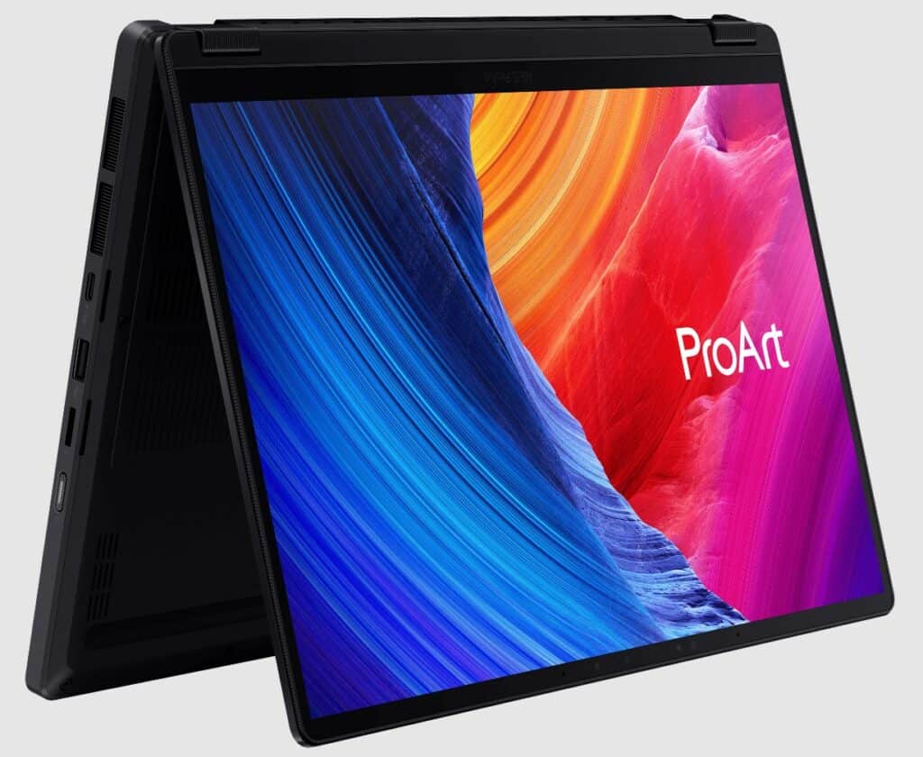 A foldable Asus laptop in tent mode displaying a colorful abstract design on its screen with the word "ProArt" visible. Showcased at Computex, this innovative device features several ports on its side, highlighting the future of Copilot+ PCs.
