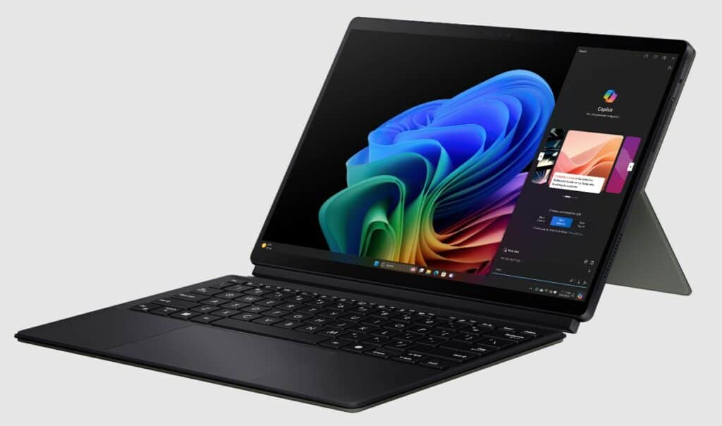 An Asus tablet with a detachable keyboard displaying a colorful screen sits on a white surface. The screen shows a vibrant design and various app icons. The black keyboard, part of the new Copilot+ PCs revealed at Computex, boasts a sleek design.