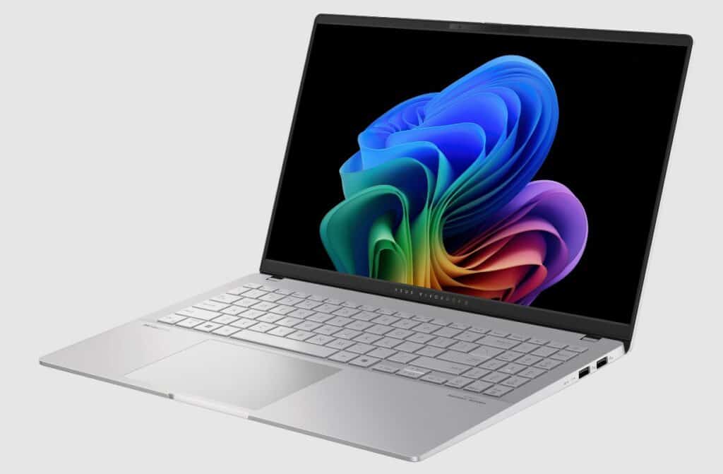 A silver Asus laptop displaying a colorful, abstract pattern on the screen. The laptop is open, showing the keyboard and touchpad, set against a plain, light gray background. This sleek device from Computex promises to be your ultimate Copilot+ in productivity and creativity.
